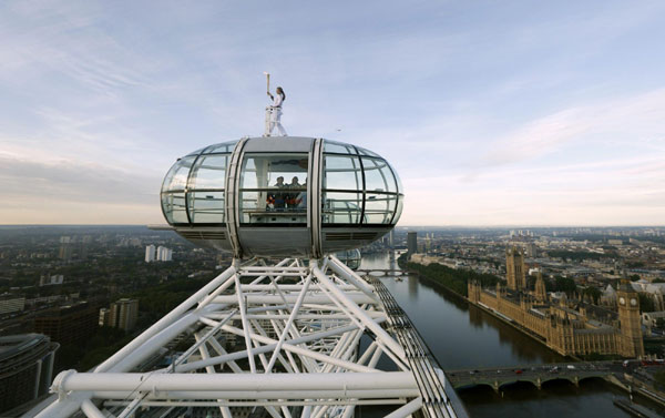 Torch bearer stands on top of London Eye