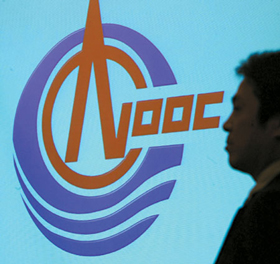 A man stands in front of a China National Offshore Oil Corporation logo during a news conference in Hong Kong on January 23.