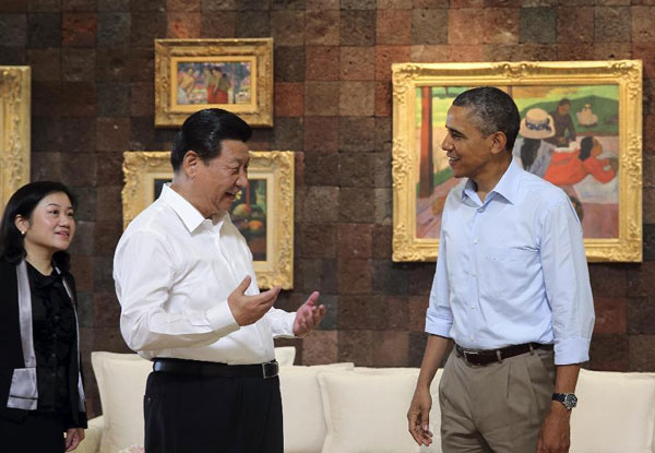 Chinese President Xi Jinping talks to US President Barack Obama prior to a joint walk before heading into their second meeting, at the Annenberg Retreat, California, the United States, June 8, 2013. Obama and Xi start talk with a walk