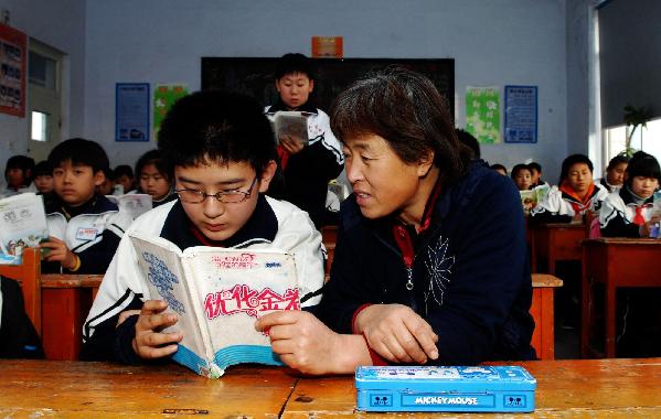 Mother and son share a desk at school Mother and son share a desk at school