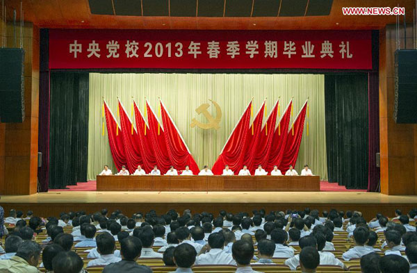 Liu Yunshan (C, back), a member of the Standing Committee of the Political Bureau of the Communist Party of China (CPC) Central Committee and president of the Party School of the CPC Central Committee, attends a graduation ceremony held by the Party School in Beijing, July 15, 2013. Liu Yunshan attends Party School graduation ceremony