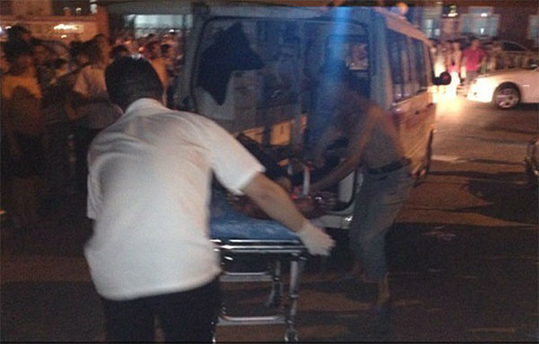 Rescuers carry a fire victim onto the ambulance after an arson targeting an entertainment center for retirees in Wenzhou, East China's Zhejiang province, on Friday night, July 27, 2013. Retiree entertainment center arson kills 2 in E China
