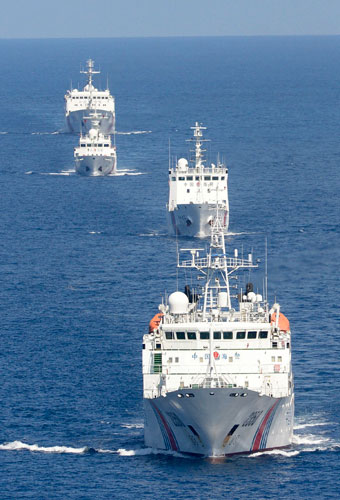 A fleet of four China Maritime Surveillance vessels are seen near disputed Diaoyu Islands, in the East China Sea, in this photo taken by Kyodo Sept 10, 2013. One year on, Diaoyu Islands patrol continues