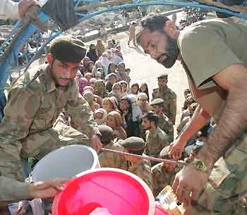 Pakistani soldiers distribute relief goods to earthquake survivors in Bagh city in Pakistani-administered Kashmir October 19, 2005.