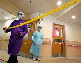 Nurses cordon a corridor inside a hospital as part of a drill on the outbreak of bird flu in Hong Kong November 8, 2005.