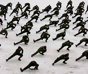 South Korean members of the Special Warfare Command stretch out on snow during an annual severe winter season drill in Pyongchang, about 180 km (113 miles) east of Seoul, January 16, 2006.