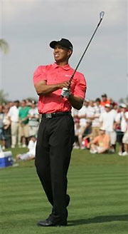 Golfer Tiger Woods watches his tee shot on the fourth tee Sunday, March 5, 2006, during the final round of the Ford Championship at Doral in Doral, Fla.