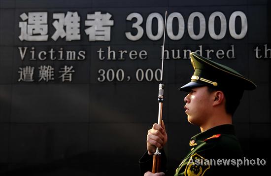 A soldier with Chinese armed police carries a gun as they march during a rehearsal of a ceremony marking the 74th anniversary of the start of the Nanjing Massacre at the Nanjing Massacre Museum, Jiangsu province Dec 12, 2011. Weekly photos: Dec 12-17