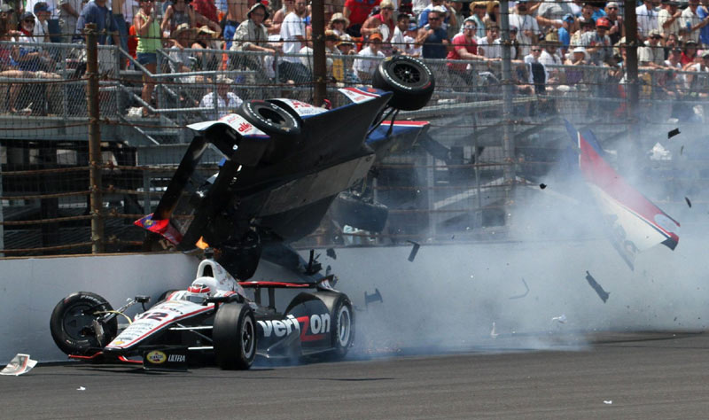 Team Penske driver Will Power of Australia, bottom, goes under the car of A.J. Foyt Enterprises driver Mike Conway of Britain during the Indianapolis 500 auto race at the Indianapolis Motor Speedway in Indianapolis, Indiana, on May 27, 2012. 2012 Sports Photos in Review: Accidents on the court