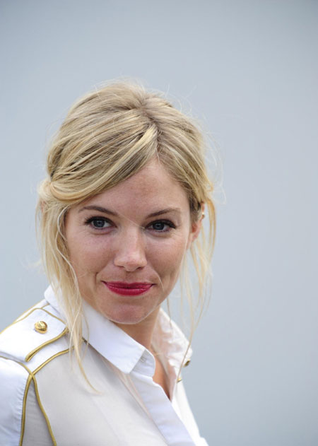 Sienna Miller poses for photographers during a photocall to promote