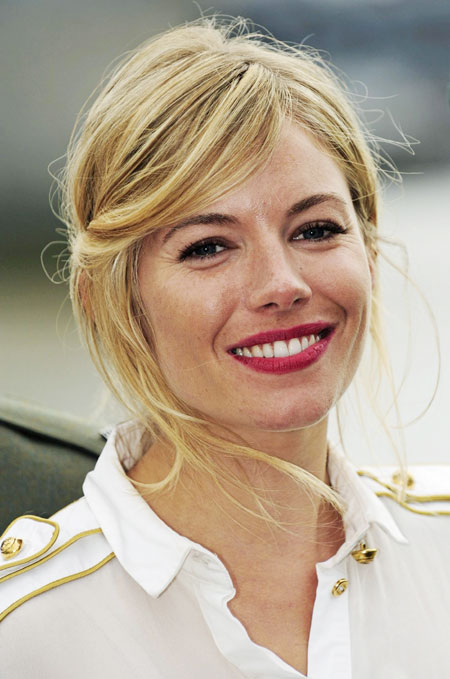 Sienna Miller poses for photographers during a photocall to promote