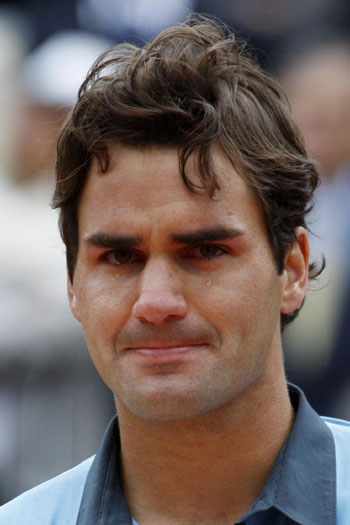 Inspired Federer conquers clay, equals record