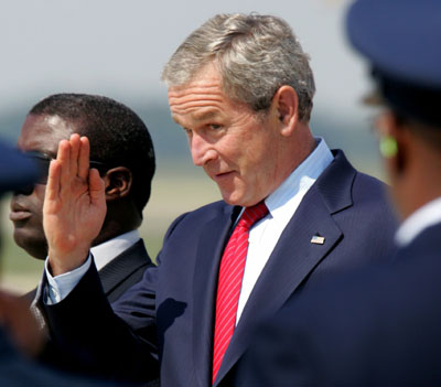 U.S. President George W. Bush salutes U.S. Air Force personnel as he steps off Air Force One returning to the United States from Russia at Andrews Air Force Base in Maryland, July 17, 2006. Bush is returning from participating in the G8 Summit in St Petersburg.