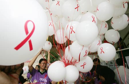 Indonesian Red Cross workers mark World AIDS Day in Jakarta December 1, 2006. Indonesia, the world's fourth most populous country, is projecting half a million HIV cases by 2010, and double that if preventive steps are not taken, the health minister said on Tuesday. 