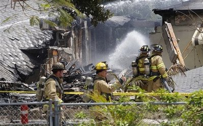 Plane splits home in half, pilot dies