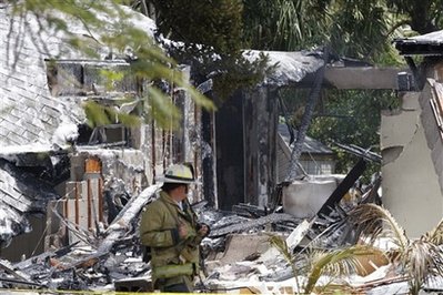 Plane splits home in half, pilot dies