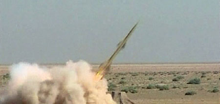 Under pressure for nukes, Iran test fires missiles