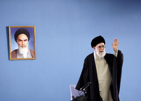 Iran's Supreme Leader Ayatollah Ali Khamenei gestures as he speaks to workers in Tehran in this April 26, 2006 file picture. Khamenei votes to open Iran's presidential poll